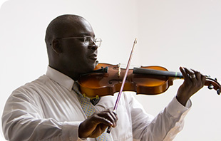 An adult violin student performing