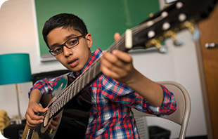 A student learning the guitar