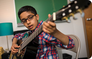 Student enjoys the guitar